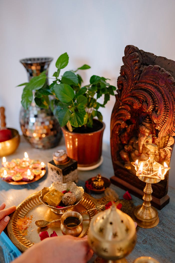 A vibrant Diwali altar setup with offerings, lighted candles, and decorative elements.